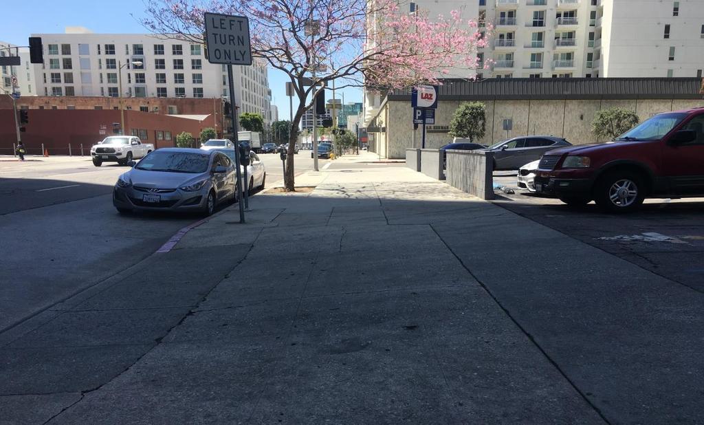 Photo 4: View of the abutting sidewalk on Olive Street,