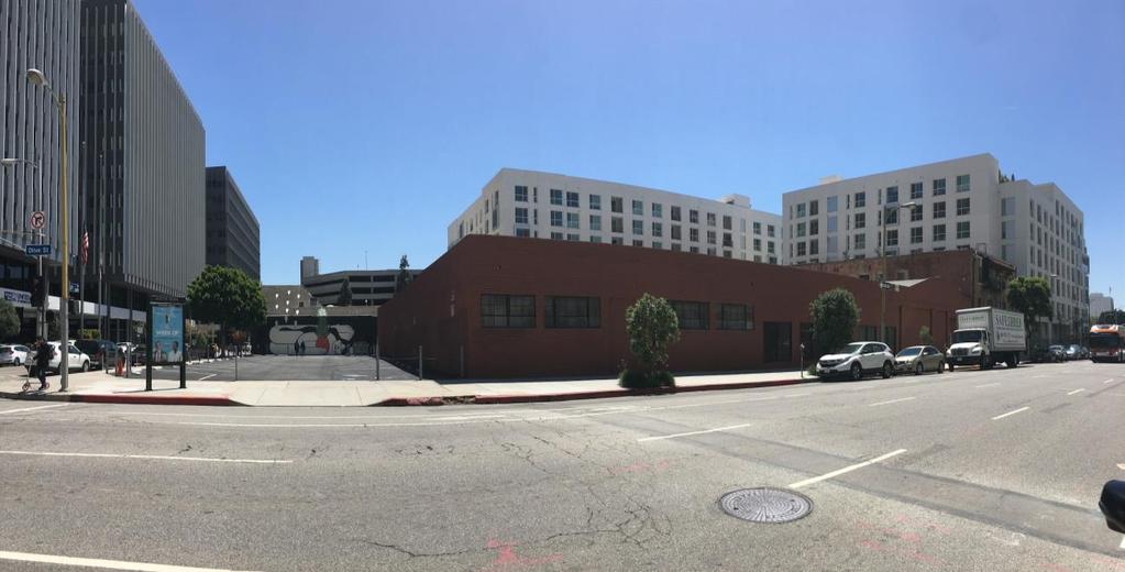 Photo 8: View of the single-story commercial building and surface parking located on the southeast corner of the 2 th Street and Olive Street