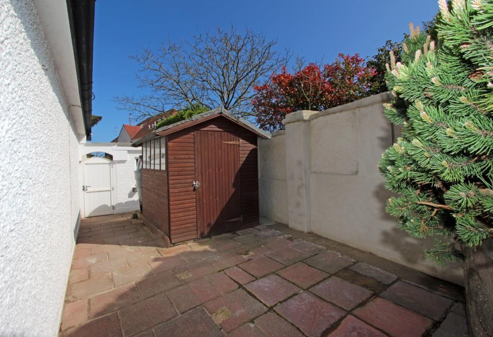 There is access down both sides of the property to the rear garden, to one side is a pedestrian gate with paved path and to the other side is a lawned garden with a gate to the rear.