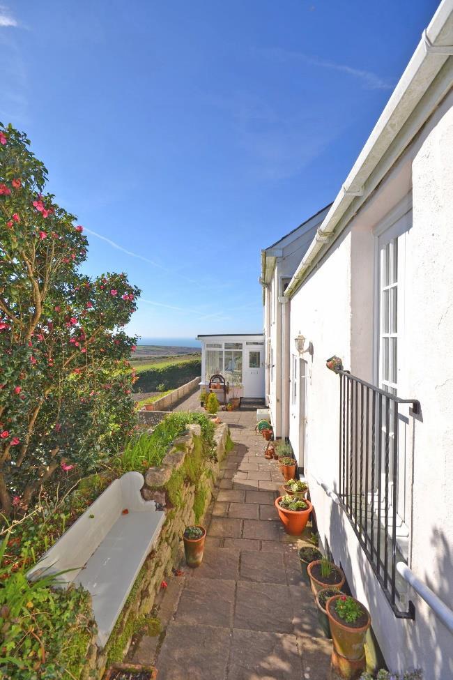 7 BEDROOM 3 10 8 x 8 3 plus inner staircase. Pair of multi pane glazed French doors opening to a wrought iron Juliet balcony and also giving views over the garden to the sea.