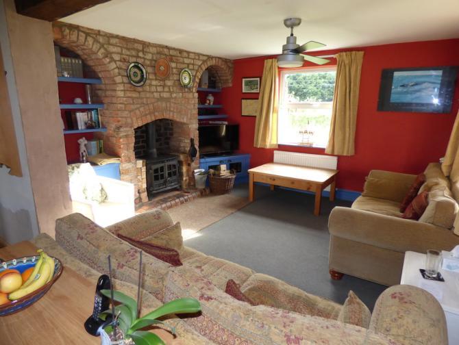 attractive full height brick chimney breast with large capacity log burner, twin arched and shelved alcoves,