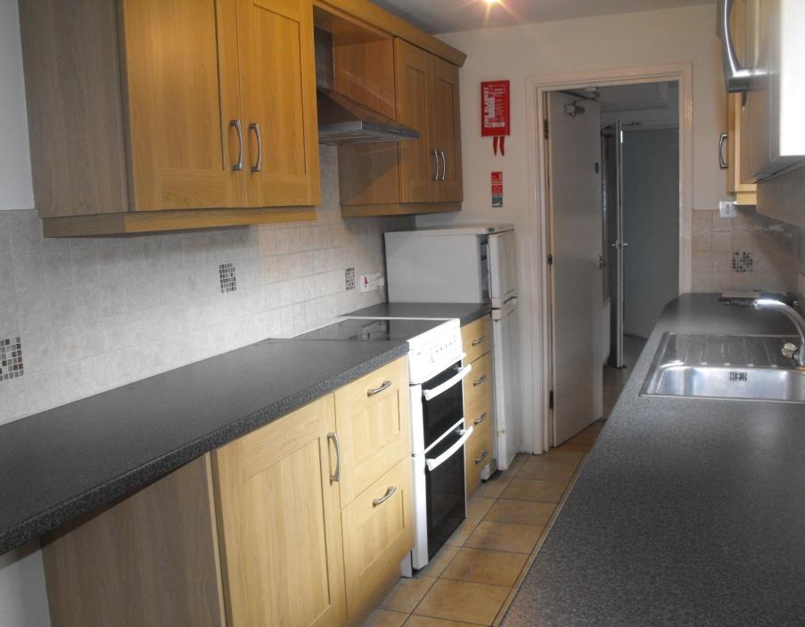 Ground Floor Kitchen at rear: 16/4 x 6/9 with part tiled walls and tiled flooring.