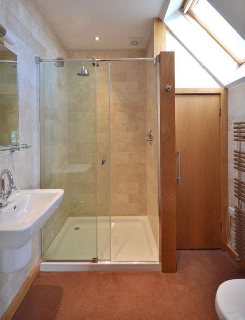 Chrome ladder style heated towel rail with additional electric element, electric shaver socket, mirror and vanity light over the wash basin, spotlights, Velux roof window in a void, extractor fan.