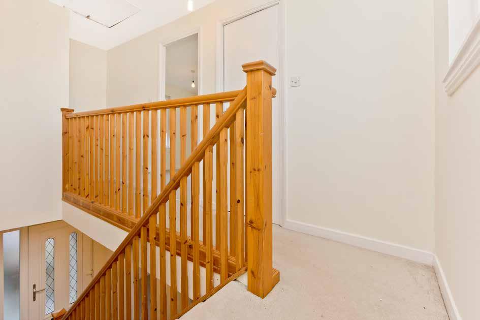 Accessed via a practical open vestibule, the front door opens into an inviting hall accommodating a deep store cupboard and a stairway accentuated by a handsome natural timber