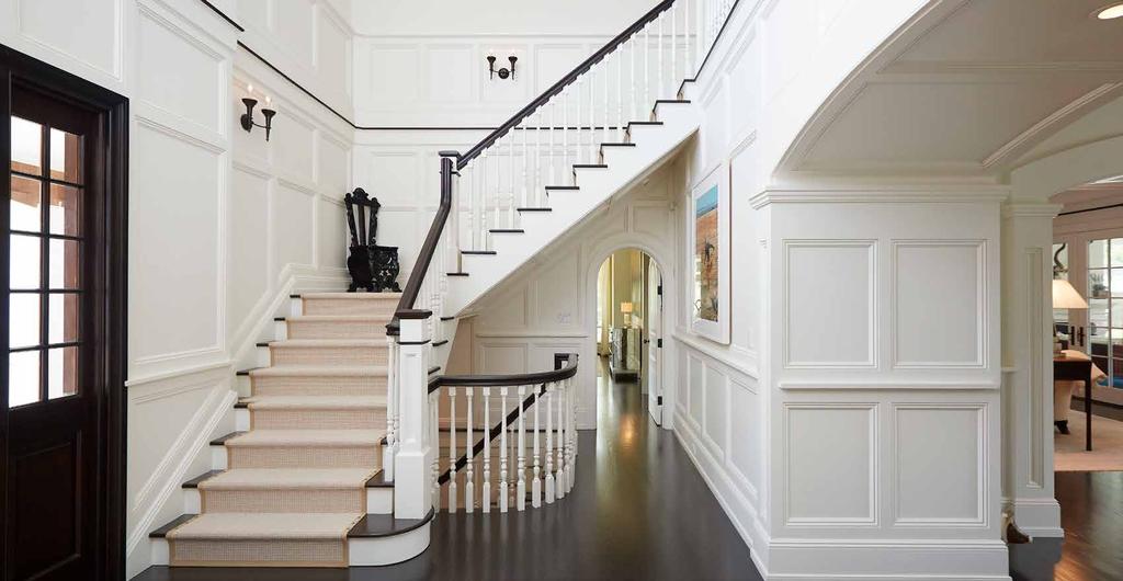 FOYER A two story foyer is anchored by a stately paneled library and private corridor to