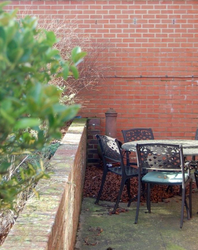 Outside the garden is stepped with a walled patio area where there s plenty of room for a table and chairs, barbecue