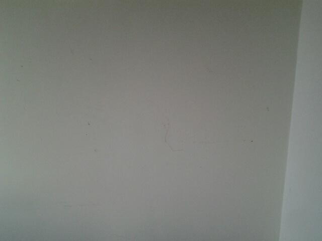 Scuff marks and paint chipped from wall.
