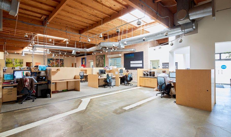 approximately 37 work stations, private corner offices, 3 conference rooms, 2 roll up doors, 3 restrooms, open kitchen, and various open work areas.