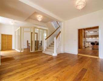 The flooring throughout is a mixture of oak flooring, carpeting and ceramic tiling.