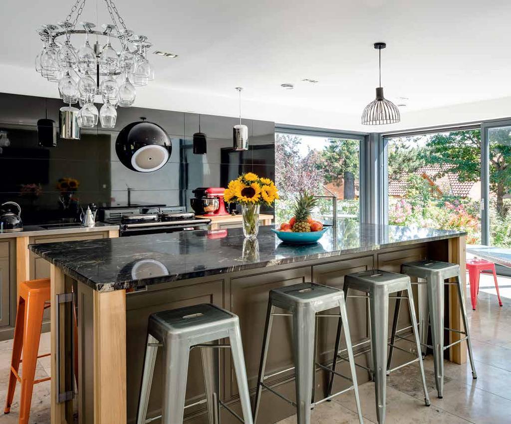 Open Spaces Oversized expanses of glazing in the form of sliding doors and double-height openings mean that the main open plan kitchen, dining and living space is bright and airy, and has a strong