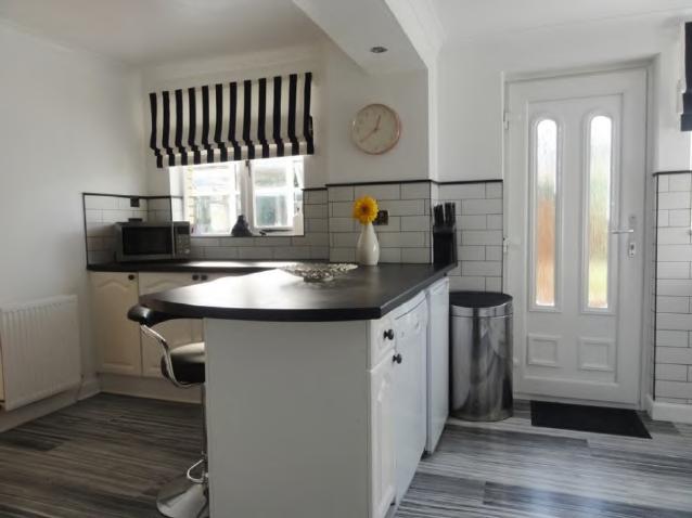 Fitted with modern white high gloss base and wall mounted units complete with gas hob, electric oven and canopy style