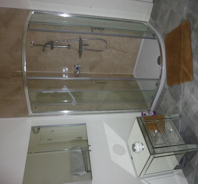 seat, wash hand basin, bidet, tile effect lino floor, fully tiled shower, tiled above