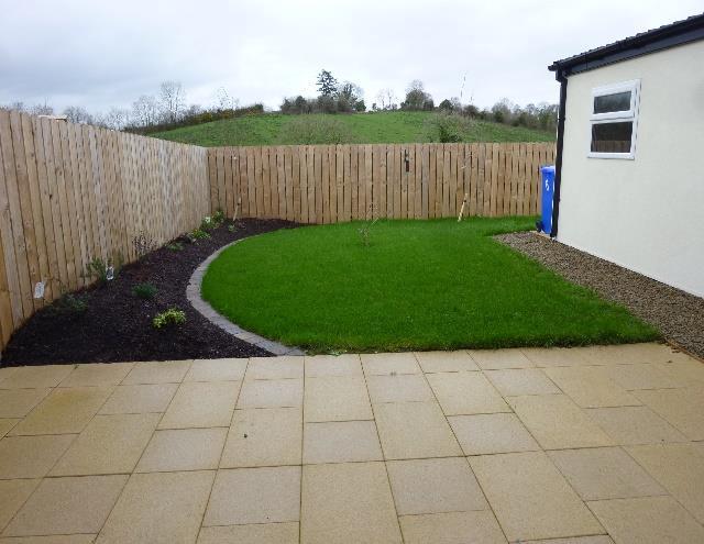 edged border bed with shrubs. A large paved sandstone effect patio area, is an ideal spot to relax.