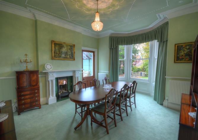Two beautifully presented reception rooms are situated either side of the central hall, which features a period spindle staircase and original tiled flooring.