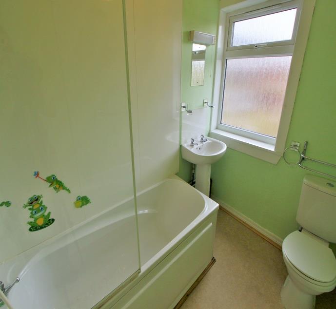 9m With white suite comprising of WC & wash basin, window to the front elevation, tiled flooring, and storage heater.
