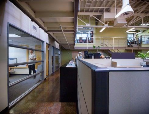 walkway, a two-story conference room, and a perfect balance of workstations and private offices.
