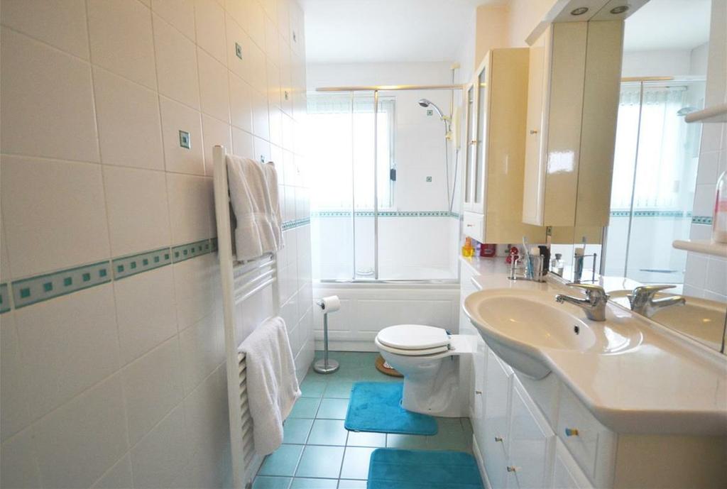 32m approx) Low level wc and vanity wash hand basin unit with worktop space over, vanity cupboards below, mirror with spotlights, shaving point