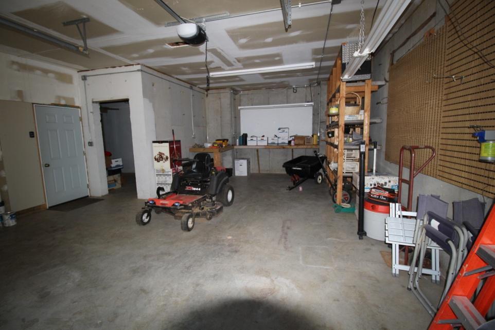 Roomy Single Garage Workshop on this level; Pegboard, shelving, workbench; Can be accessed from