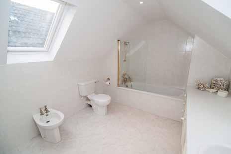 DRESSING AREA: 7 0 x 5 0 (2.13m x 1.52m) approx. Two deep built-in wardrobes. Leading to... ENSUITE BATHROOM: 11 5 x 9 0 (3.48m x 2.