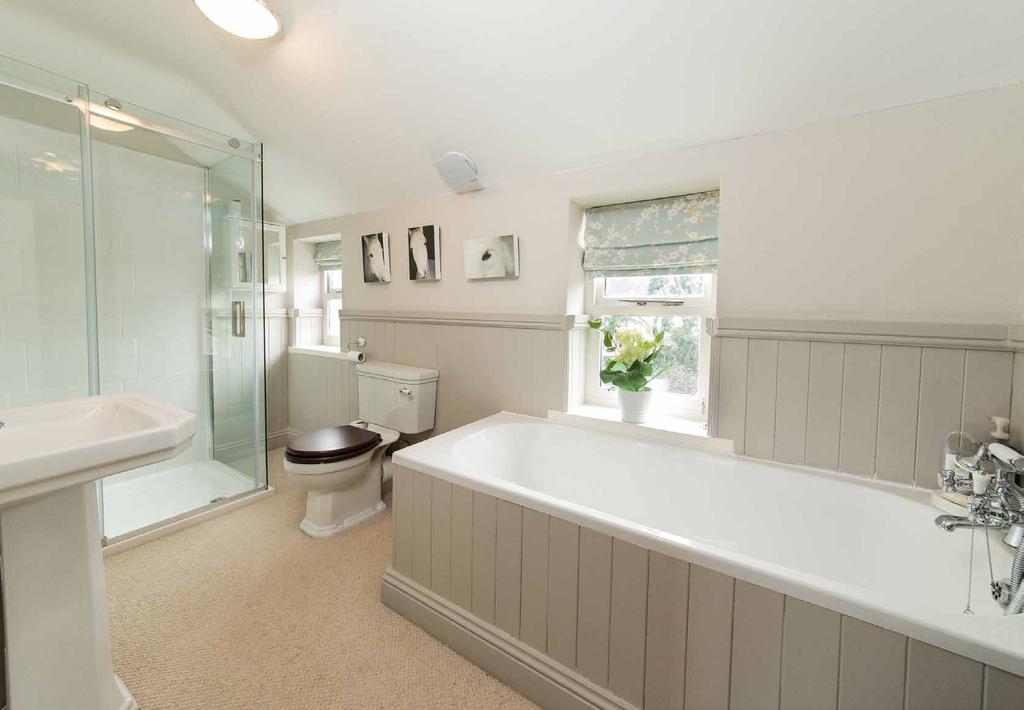 basin, heated towel rail and WC. There are three further characterful bedrooms, all with garden views.