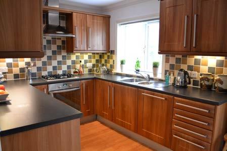 29m) Beautiful modern wrap around fitted kitchen in dark wood comprising of wall base and drawer units to include integrated microwave, dishwasher,