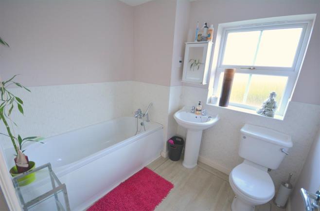 BATHROOM 2.37m (7' 9") x 2.02m (6' 8") The family bathroom comprises of a low level WC, wash hand basin and panelled bath.