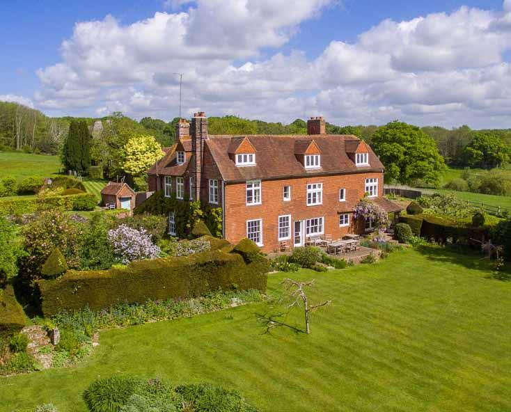 JACOBS FARM A charming country estate comprising a Grade II Listed house, set up a drive and centrally placed within its own land amidst beautiful mature gardens with wonderful southerly views over