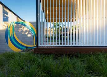 Darroch s abstract painting has been installed on the western face of a new landscape wall that defines a small deck and staircase leading to an outdoor garden room.
