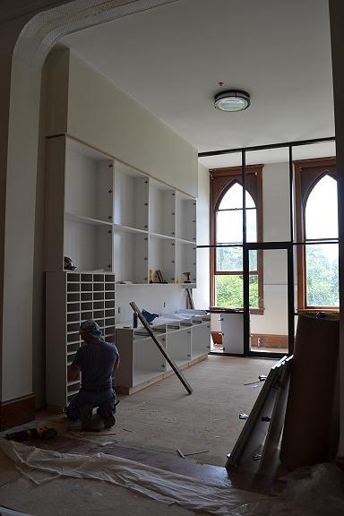Jun 12 Cabinetry for the new mailroom on 2 nd Ottilia) being installed; phone booth glass wall will provide much