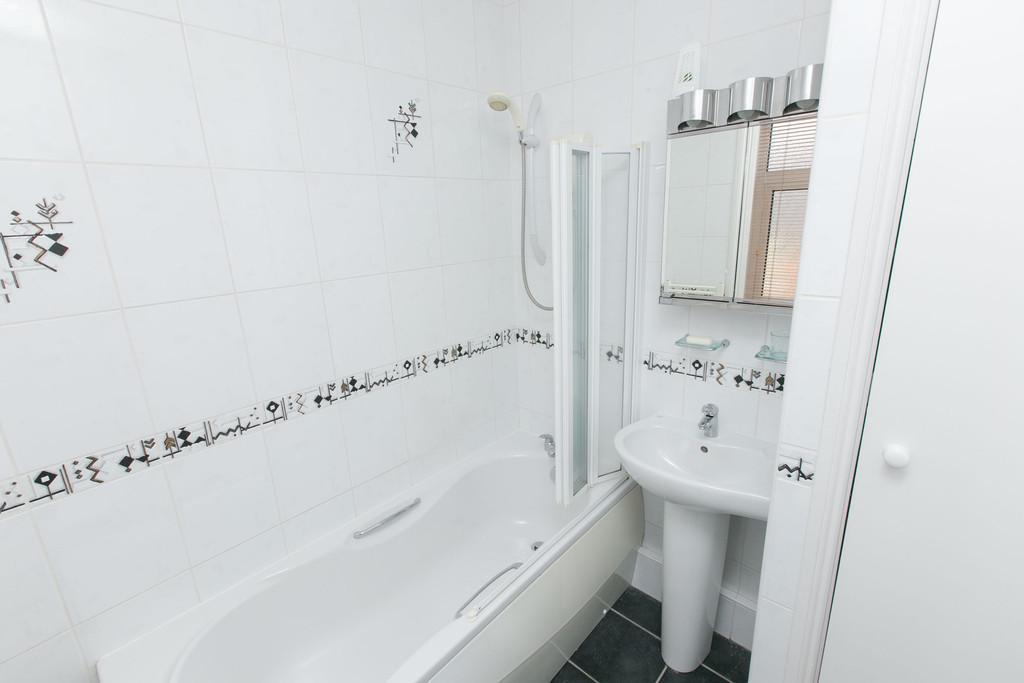 BATHROOM Modern white suite comprising low flush w.c. Pedestal wash hand basin with mixer taps.
