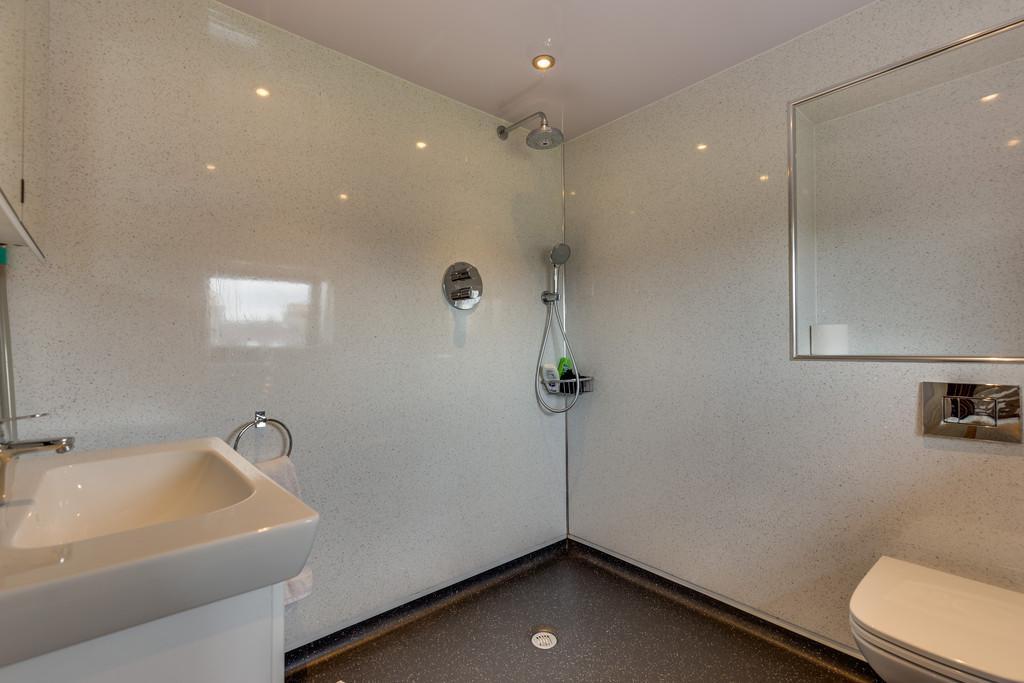 Two circular wall mirrors with lights, vertical towel radiator, extractor fan and UPVC double glazed window. Bedroom 4 with Ensuite Half Landing with stairs to first floor.