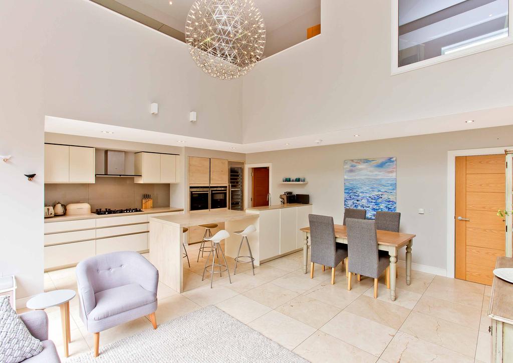 On the lower ground-floor, a further hall houses a convenient WC and affords access to the very heart of this executive home; a vast south-facing kitchen set beside a generous area for relaxing and