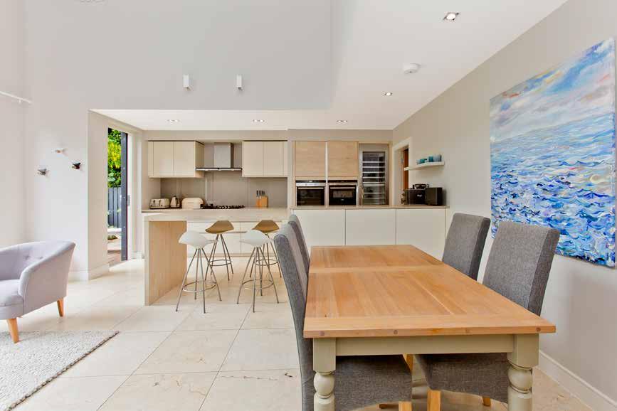 Impeccably presented with an ultra-sleek finish, the kitchen is fitted with flat-panel cabinets paired with resilient granite worktops and a congenial breakfast bar peninsula.