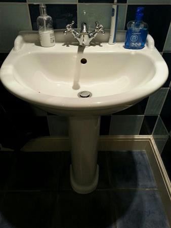 White sink, wall mounted, floor mounted with chrome mixer