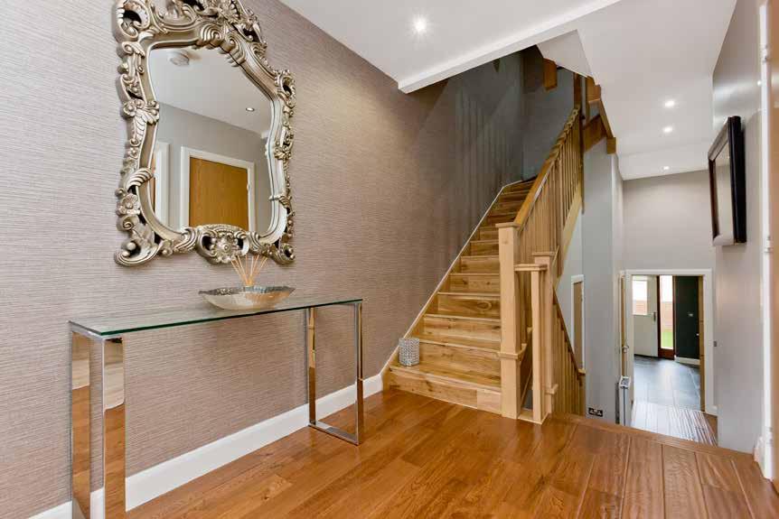 room. A handsome oak staircase in the hall ascends to the principal living space on the first floor, which
