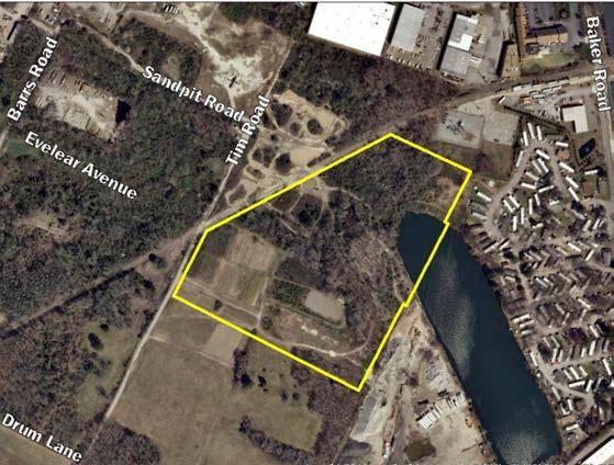 Industrial South Undeveloped land / I-1 Light Industrial East Mobile home park / A-12 Apartment West Tim Road and wooded vacant land / I-1 Light