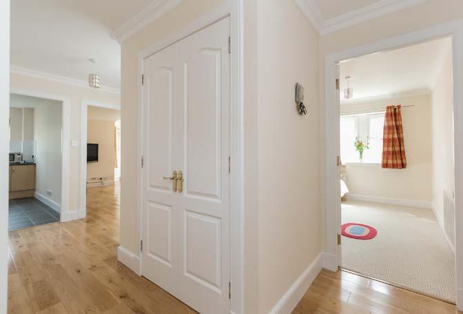 and solid lightwood floor which carries on through to the spacious sitting/dining room with generous five window bay easily capable of taking a dining table and chairs, fully fitted dining kitchen