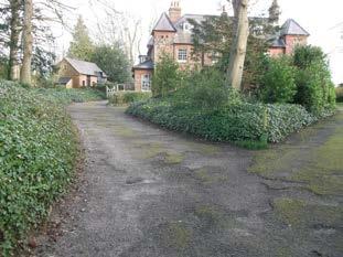 There is a tarmac driveway from the entrance gate to the front door of the house. The paths around the house are a mixture of tarmac and grass with paving slabs. 2.