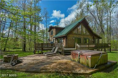 room. This home offers a great screened in sunroom, large deck, and a hot tub for your enjoyment. Lake access with a dock slip allows you to enjoy all that Deep Creek Lake has to offer.