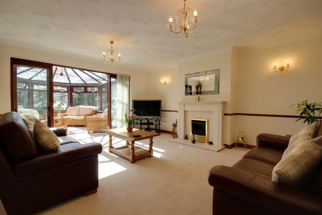 78 approx) A spacious room having as its focal point a feature limestone fireplace, hearth and backplate housing a