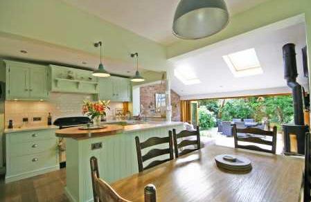 feature fireplace, stunning family living kitchen with folding doors accessing the garden, access to a