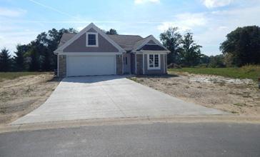 8 x14 covered patio, oversized 2 1/2 car garage and an open floor plan.