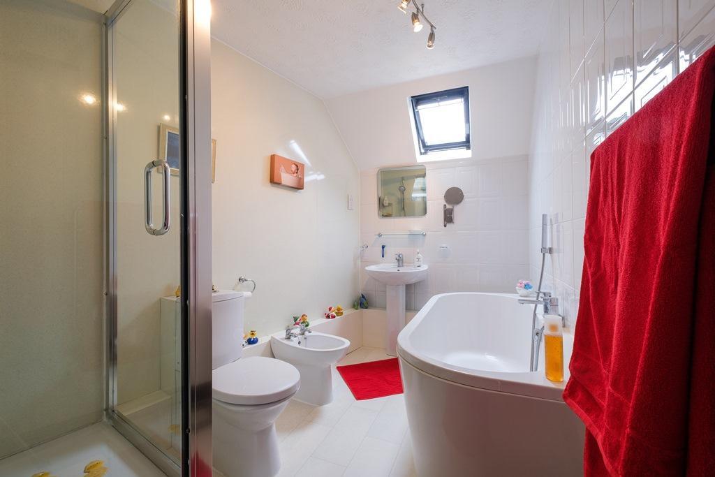BATHROOM: Fitted with a five piece suite comprising a panel bath with centre mixer tap shower, glazed shower cubicle with mains fed shower and external