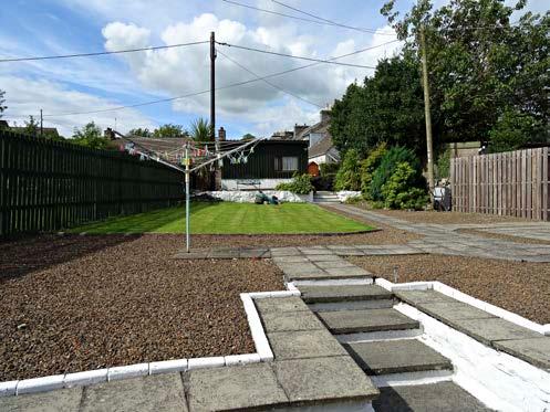 The garden grounds have a paved patio area with steps leading to the lawn and detached garage / workshop (5m