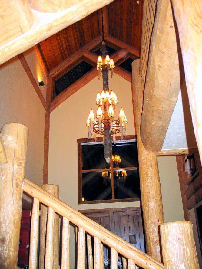 From the main staircase, a look back, at night, shows the high ceilings and unique foyer chandelier.