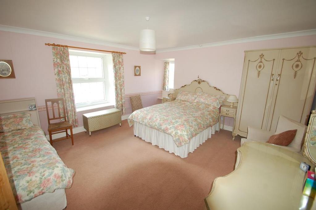 BEDROOM ONE 15ft x 13.3ft (4.57m x 4.05m) A lovely double bedroom with double aspect North and West and attractive views over open countryside, radiator, coving.
