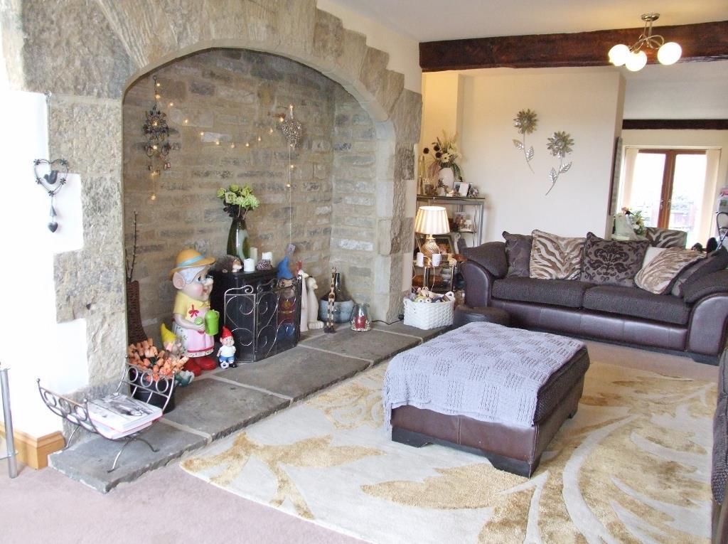 Double central heating radiator and alarm pad. Lounge 7.04m (23' 1") x 4.30m (14' 1") Featuring a stunning large stone inglenook fireplace and hearth, with flue, and beams to the ceiling.