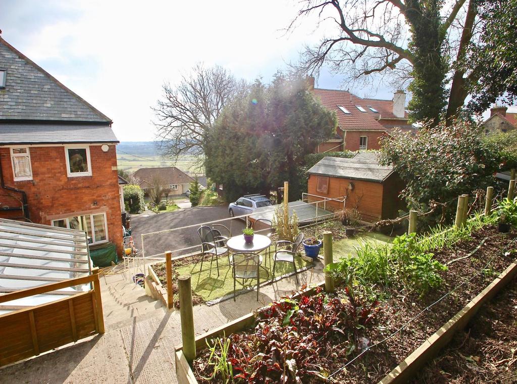 Here there is a front garden with patio terrace, lawn and inset stone 'Labrynth', all taking in the beautiful south and westerly views to the moor,