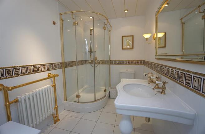ENSUITE BATHROOM The master bedroom benefits from a ensuite shower room comprising a large curved shower cubicle with