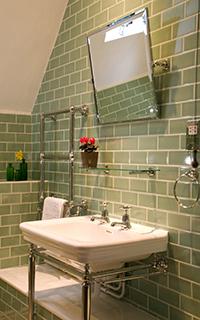 Upstairs Bathroom Tiled flooring WC, basin and shower above bath The WC is 410mm high, with a push button for the flush The sink is 850mm high, with separate turn taps The bath edge is 580mm from the